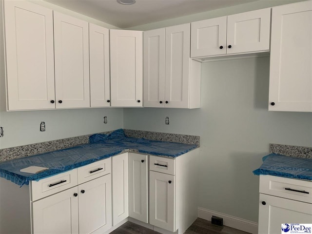 laundry room with baseboards