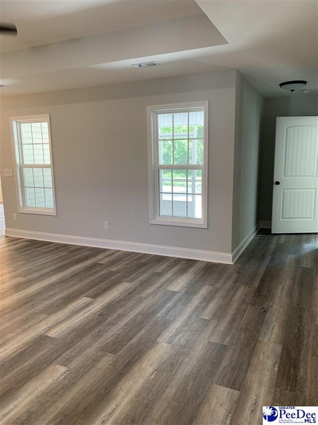 7423 E National Cemetery Rd, Florence, SC 29506 - spare room featuring baseboards and dark wood finished floors