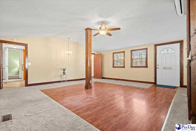 interior space with vaulted ceiling, wood-type flooring, ceiling fan, and a textured ceiling