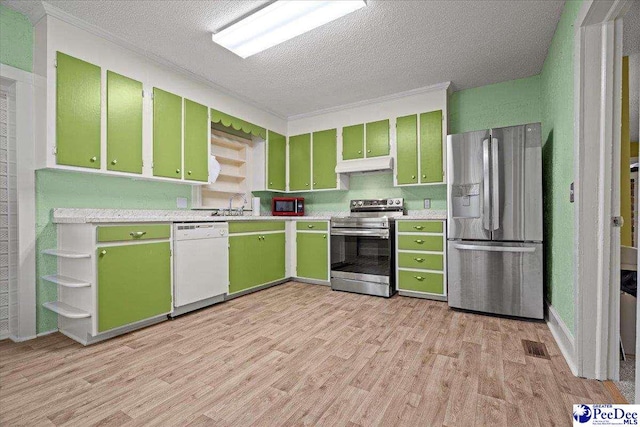 kitchen with stainless steel appliances, light hardwood / wood-style flooring, and green cabinetry