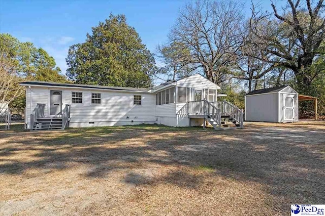 manufactured / mobile home with a sunroom and a shed