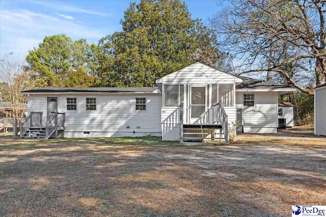 view of front of home with a sunroom and central AC unit