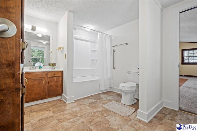 bathroom featuring vanity, toilet, curtained shower, and a textured ceiling