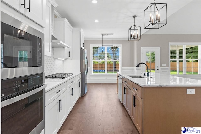 2104 Lacy St, Florence, SC 29505 - kitchen with stainless steel appliances, dark wood-style floors, an island with sink, a chandelier, and recessed lighting