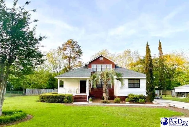 bungalow-style home with a porch, a front lawn, and fence