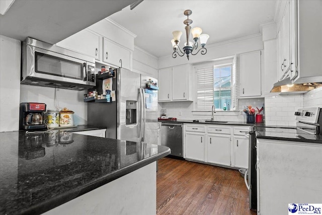 314 W Cedar St, Florence, SC 29501 - kitchen with crown molding, an inviting chandelier, a sink, stainless steel appliances, and dark wood-type flooring