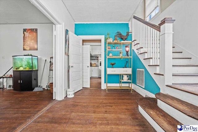 314 W Cedar St, Florence, SC 29501 - staircase featuring visible vents, ornamental molding, and wood finished floors
