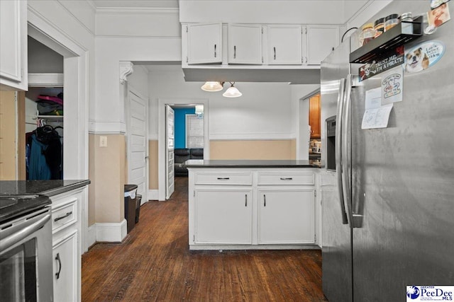 314 W Cedar St, Florence, SC 29501 - kitchen with dark countertops, white cabinets, stainless steel appliances, and dark wood-type flooring