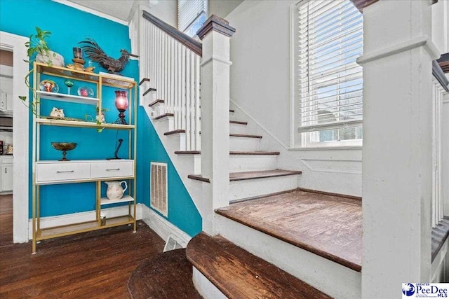 314 W Cedar St, Florence, SC 29501 - staircase with decorative columns, baseboards, visible vents, and wood finished floors