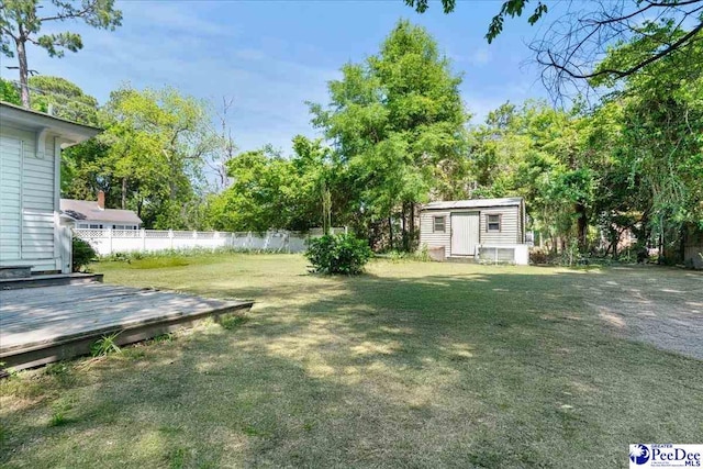 314 W Cedar St, Florence, SC 29501 - view of yard with fence, an outbuilding, a deck, and a shed