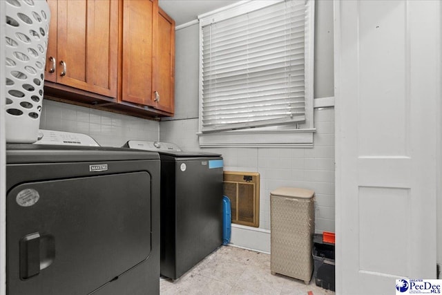 314 W Cedar St, Florence, SC 29501 - washroom with cabinet space, washing machine and dryer, and tile walls