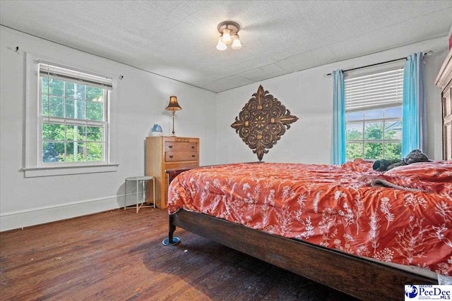 314 W Cedar St, Florence, SC 29501 - bedroom featuring baseboards, a textured ceiling, and wood finished floors
