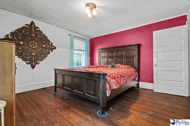314 W Cedar St, Florence, SC 29501 - bedroom featuring baseboards, a textured ceiling, and wood finished floors