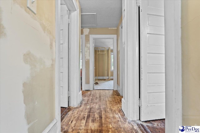314 W Cedar St, Florence, SC 29501 - hall with baseboards, attic access, a textured ceiling, and wood finished floors