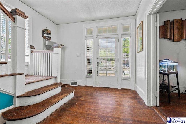 314 W Cedar St, Florence, SC 29501 - foyer entrance featuring stairway, a textured ceiling, wood finished floors, and visible vents