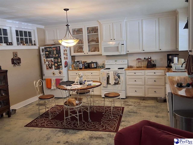 kitchen featuring white cabinetry, white appliances, sink, and hanging light fixtures