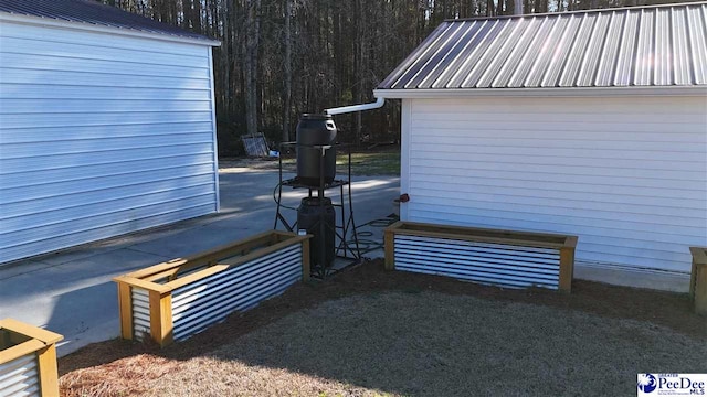 rear view of house with metal roof and fence