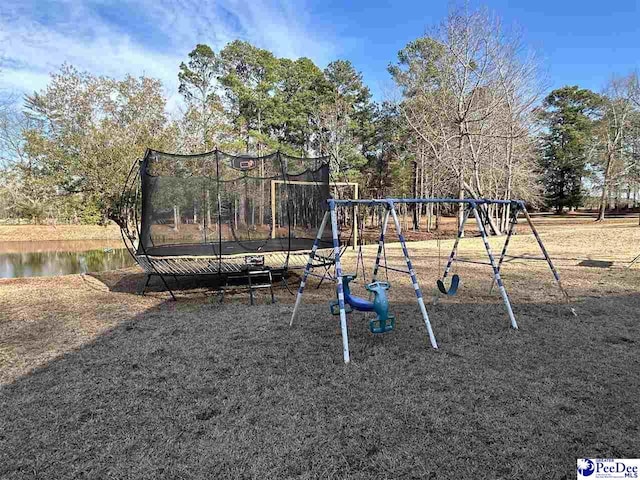 view of jungle gym featuring a water view and a trampoline