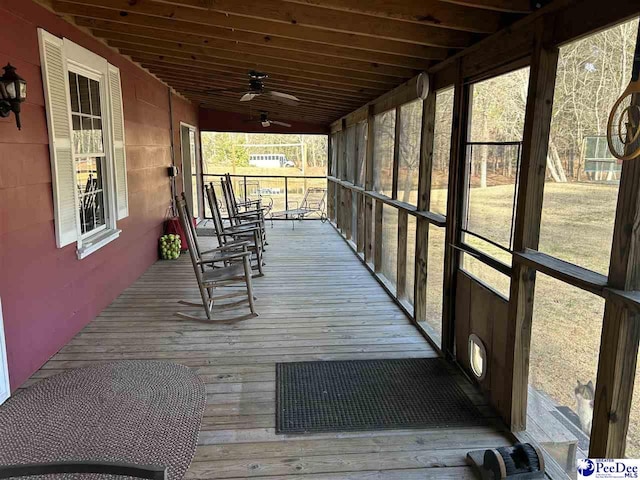 deck with ceiling fan and covered porch