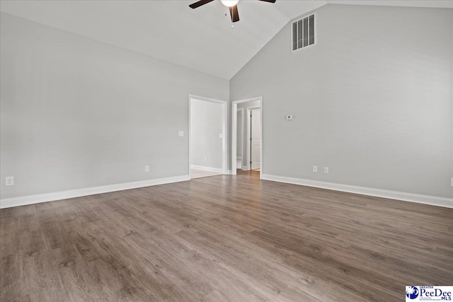 unfurnished room featuring visible vents, baseboards, a ceiling fan, wood finished floors, and high vaulted ceiling