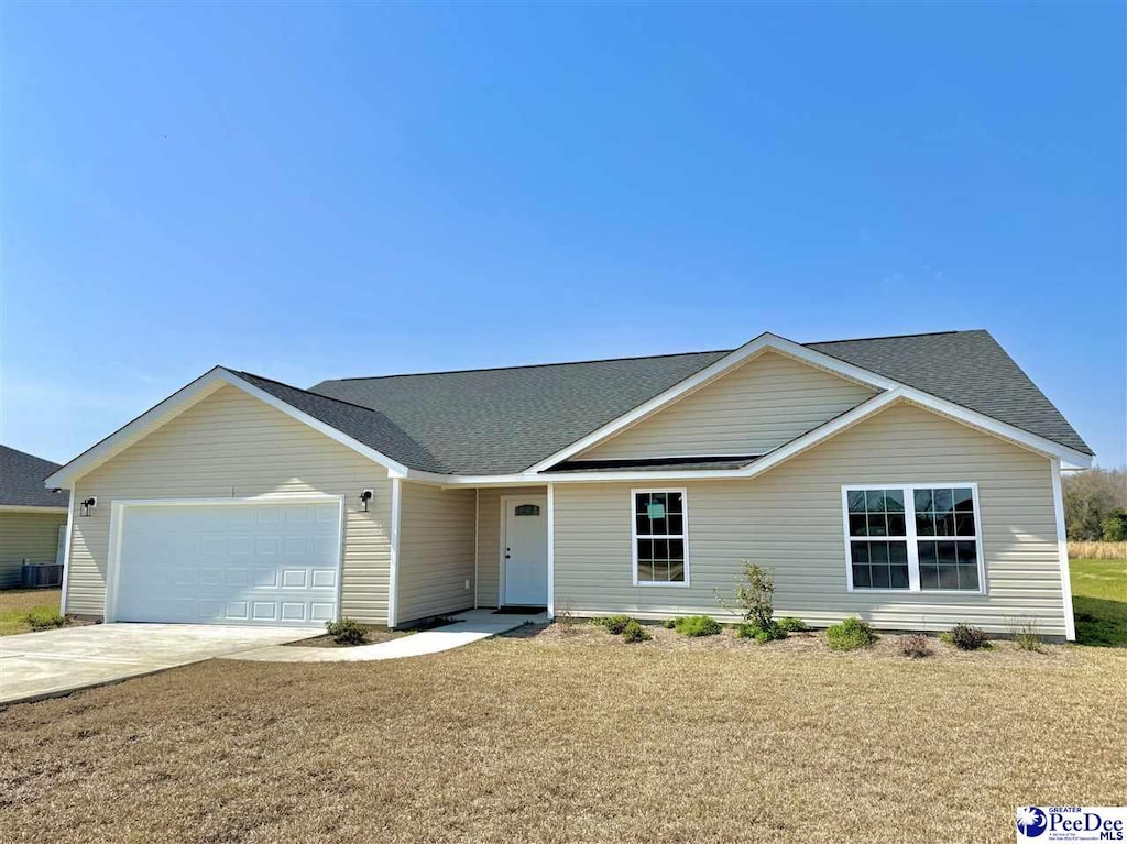 ranch-style house featuring an attached garage, concrete driveway, a front yard, and a shingled roof