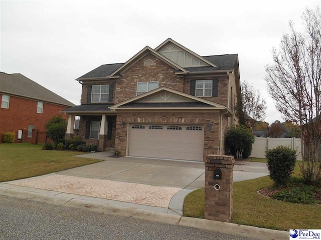 craftsman inspired home featuring a garage and a front yard