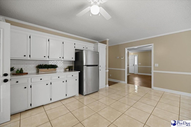 838 Greenwing Teal, Florence, SC 29505 - kitchen with decorative backsplash, freestanding refrigerator, and a textured ceiling