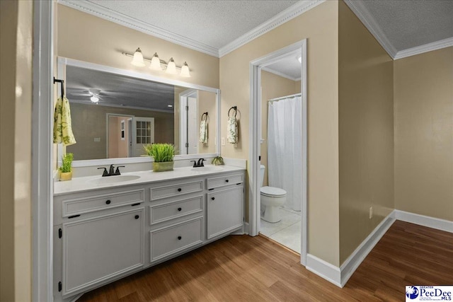 838 Greenwing Teal, Florence, SC 29505 - full bathroom featuring a textured ceiling, wood finished floors, double vanity, and a sink