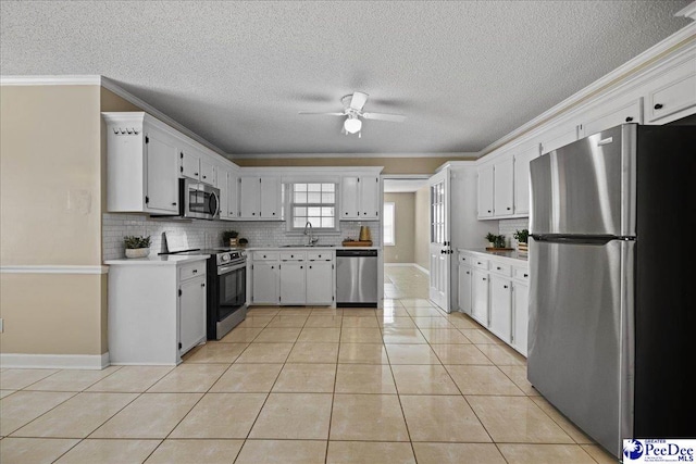 838 Greenwing Teal, Florence, SC 29505 - kitchen with light tile patterned floors, a sink, light countertops, appliances with stainless steel finishes, and a ceiling fan
