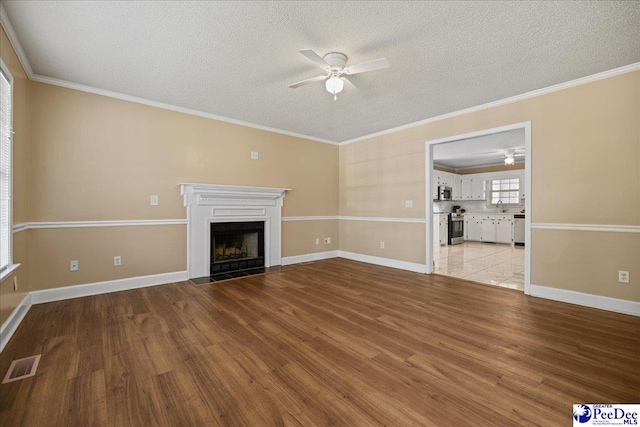 838 Greenwing Teal, Florence, SC 29505 - unfurnished living room with visible vents, ceiling fan, wood finished floors, and a textured ceiling