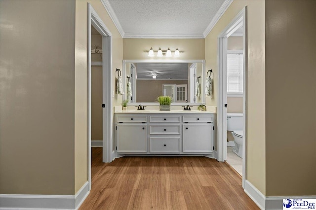 838 Greenwing Teal, Florence, SC 29505 - bathroom featuring toilet, crown molding, wood finished floors, and a sink