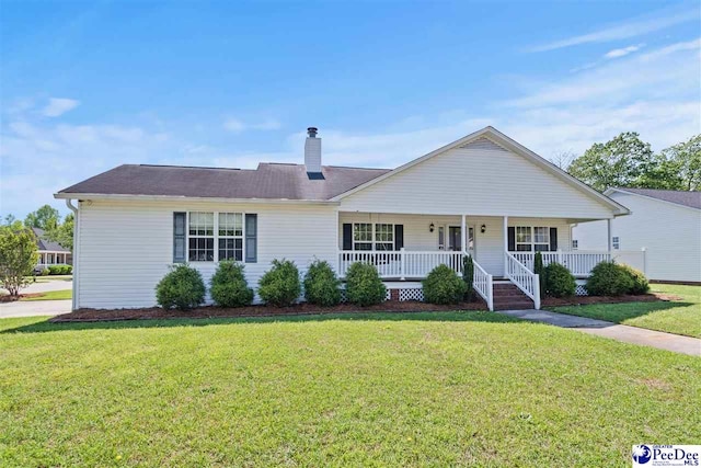 838 Greenwing Teal, Florence, SC 29505 - view of front of house featuring a porch, a front lawn, and a chimney