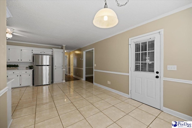 838 Greenwing Teal, Florence, SC 29505 - unfurnished dining area with a ceiling fan, a textured ceiling, light tile patterned floors, and ornamental molding