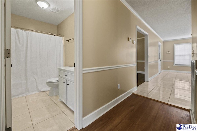 838 Greenwing Teal, Florence, SC 29505 - hall with light tile patterned floors, a textured ceiling, ornamental molding, visible vents, and baseboards