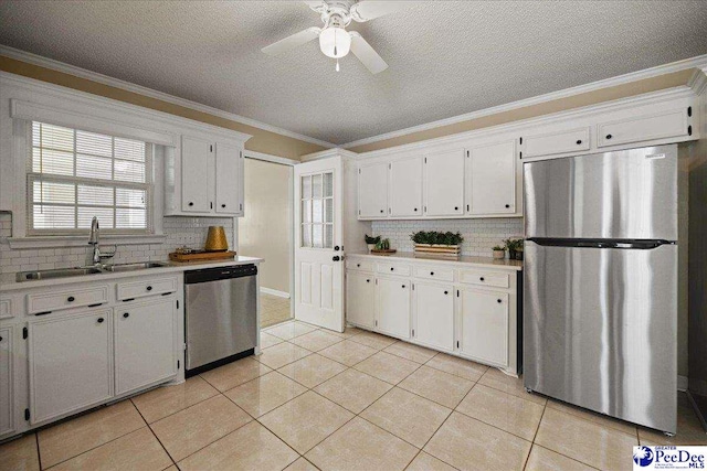 838 Greenwing Teal, Florence, SC 29505 - kitchen featuring crown molding, tasteful backsplash, white cabinetry, appliances with stainless steel finishes, and a sink