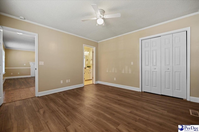 838 Greenwing Teal, Florence, SC 29505 - unfurnished bedroom featuring a textured ceiling, dark wood-style flooring, ornamental molding, and visible vents