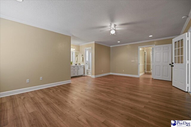 838 Greenwing Teal, Florence, SC 29505 - unfurnished living room featuring baseboards, a ceiling fan, crown molding, and wood finished floors