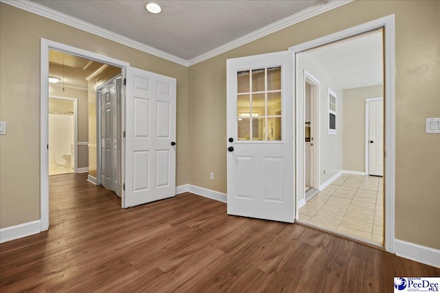 838 Greenwing Teal, Florence, SC 29505 - foyer entrance featuring a textured ceiling, baseboards, ornamental molding, and wood finished floors