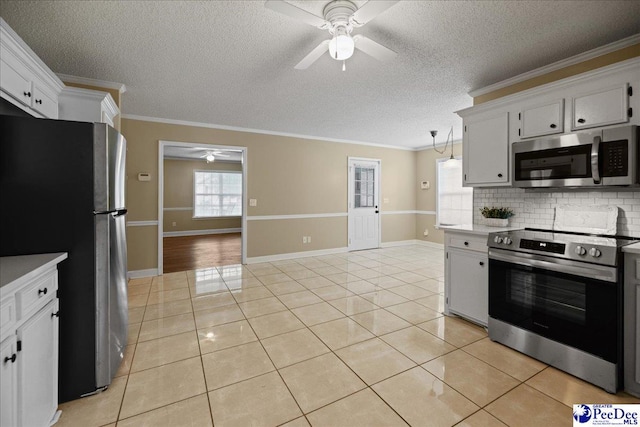 838 Greenwing Teal, Florence, SC 29505 - kitchen with appliances with stainless steel finishes, a ceiling fan, a textured ceiling, backsplash, and light tile patterned flooring