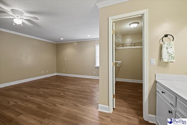 838 Greenwing Teal, Florence, SC 29505 - bathroom with baseboards, a textured ceiling, a ceiling fan, crown molding, and wood finished floors