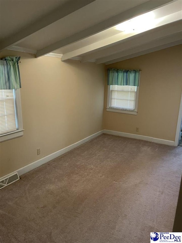 spare room with carpet and vaulted ceiling with beams