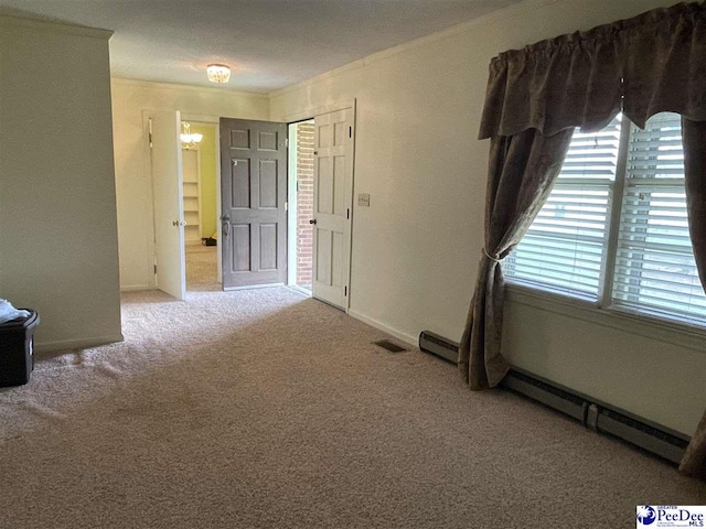 carpeted spare room featuring ornamental molding