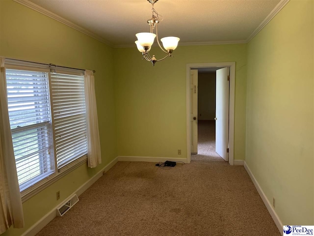 carpeted empty room with crown molding and a chandelier