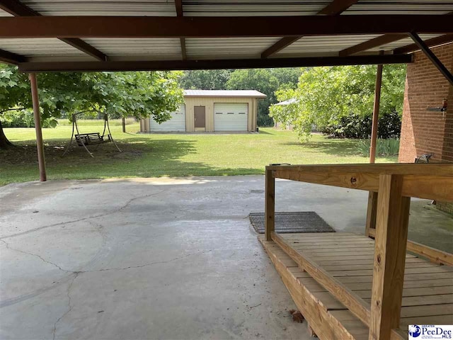 view of patio / terrace featuring a garage and an outdoor structure