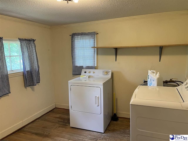 washroom with hardwood / wood-style floors, washer and clothes dryer, ornamental molding, and a textured ceiling