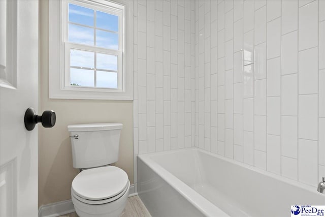 2528 Edinberg Way, Florence, SC 29501 - bathroom featuring toilet, baseboards, and washtub / shower combination