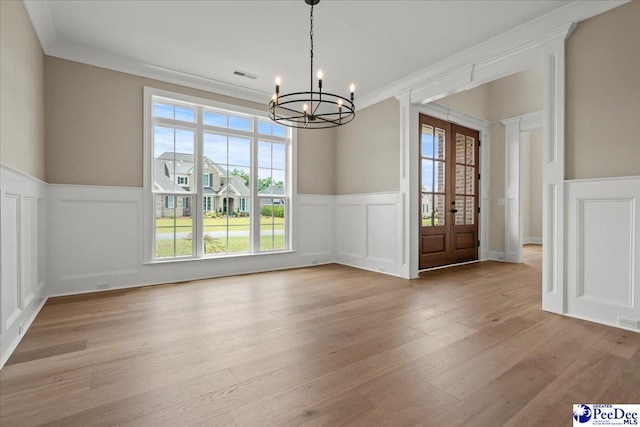2528 Edinberg Way, Florence, SC 29501 - unfurnished dining area featuring a decorative wall, a chandelier, plenty of natural light, a wainscoted wall, and wood finished floors