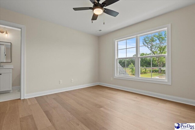 2528 Edinberg Way, Florence, SC 29501 - empty room with light wood finished floors, baseboards, and a ceiling fan