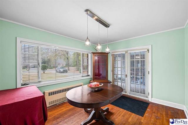 600 Greenway Dr, Florence, SC 29501 - dining space with radiator, wood finished floors, baseboards, and ornamental molding