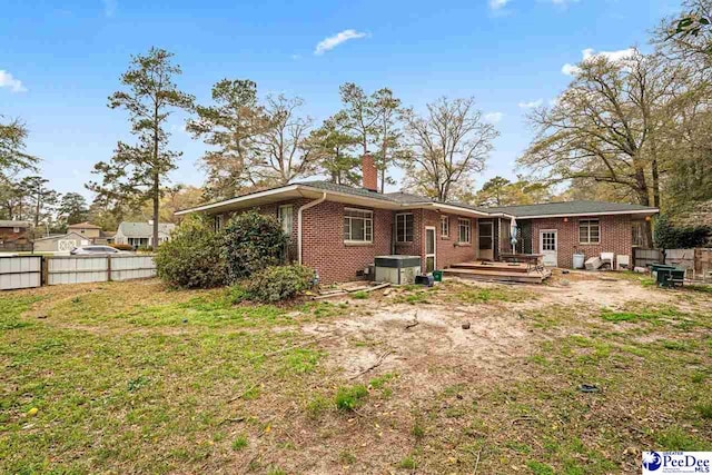 600 Greenway Dr, Florence, SC 29501 - rear view of property featuring a yard, brick siding, a chimney, and fence